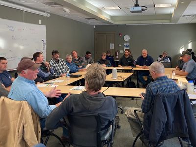 A group of people having a meeting in a conference room.
