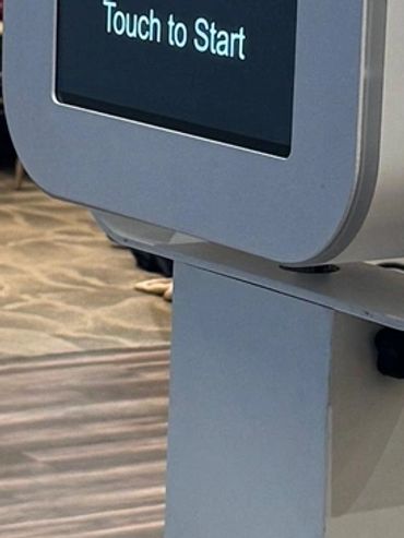 Photo booth with colorful hats in the foreground at an indoor event.