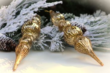 A stunning set of 11" Brass Mercury Glass Finial Ornaments with glitter motif from Raz Imports.