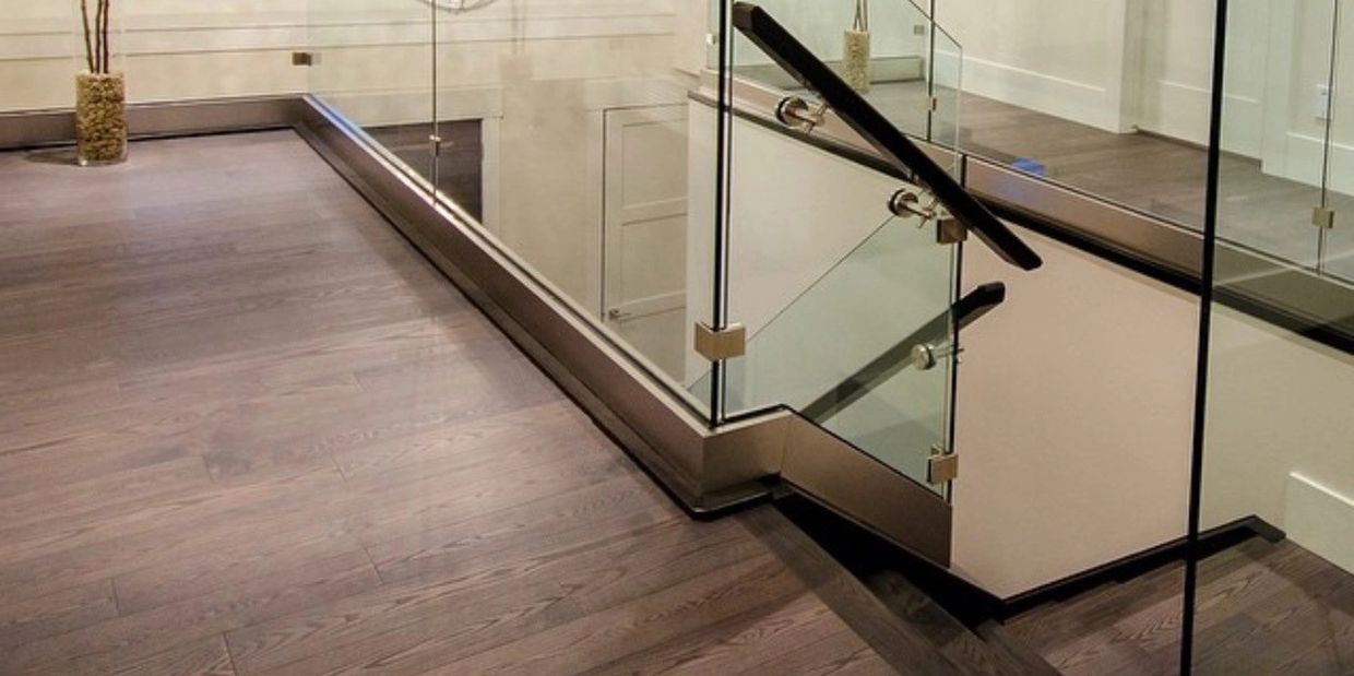 glass railings and hardwood stairs and crystal light with home decor and windows