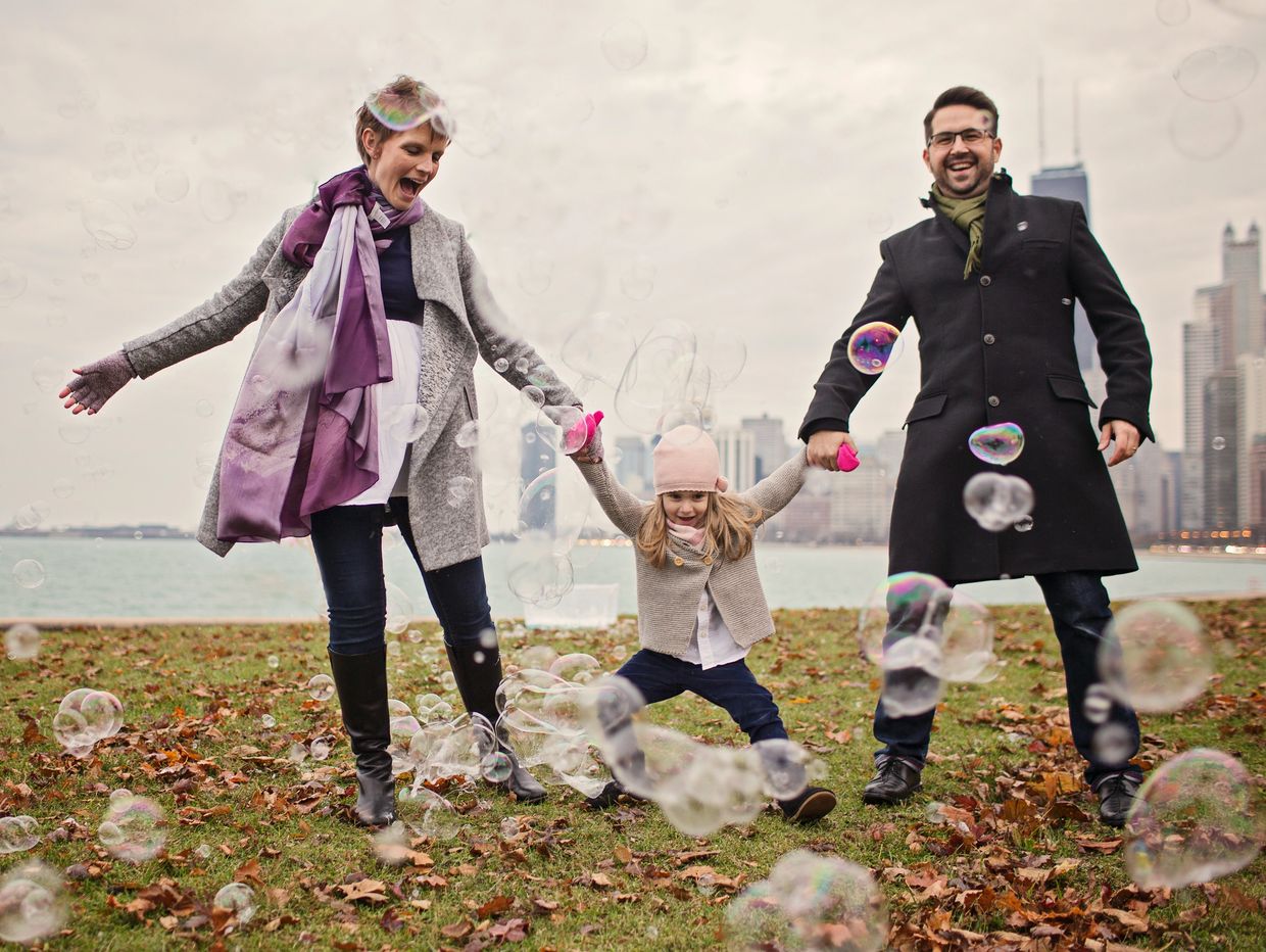 People enjoying a family photography session at North Avenue beach with bubbles.