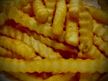 Close-up of crinkle-cut French fries.