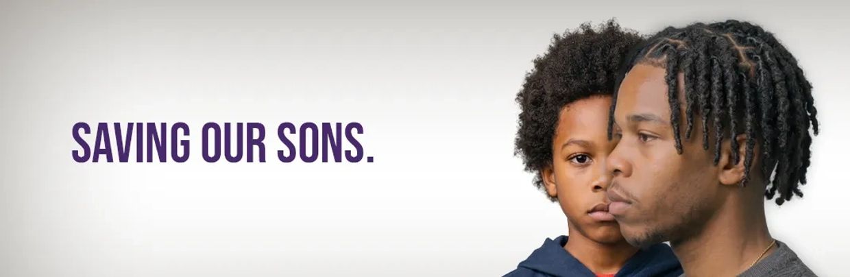 A young black man in profile in front of a black child straight on.