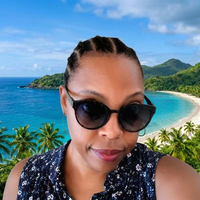 Woman wearing sunglasses at a tropical beach.