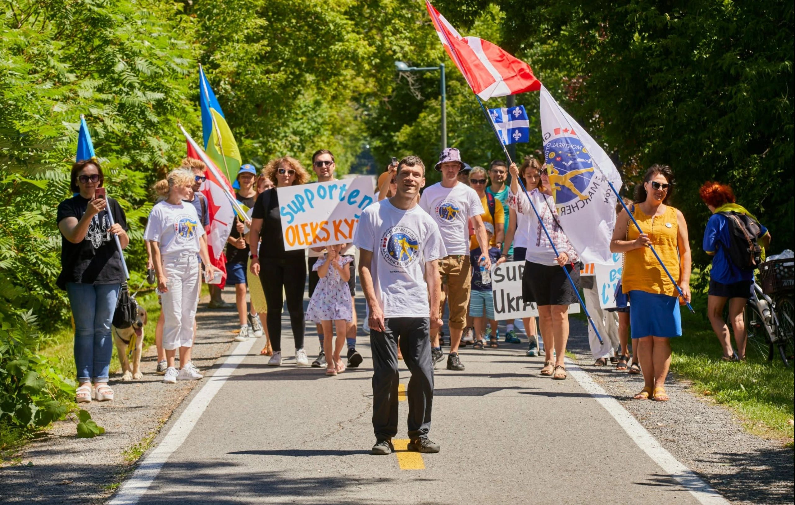 Group marching in support of Oleksiy, holding flags and signs.