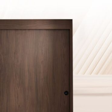 Close-up of a modern wooden door with a dark handle.