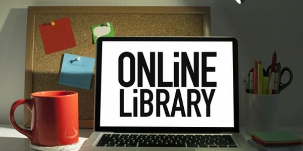 Laptop screen displaying 'ONLINE LIBRARY' with a red mug and stationery nearby.