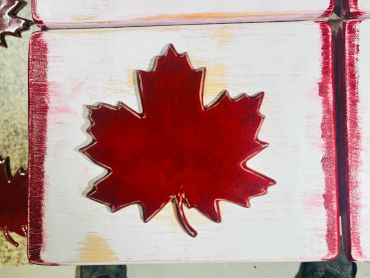 Red Canadian maple leaf decoration on wooden blocks.