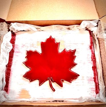 Decorative Canadian flag-themed item in a box.