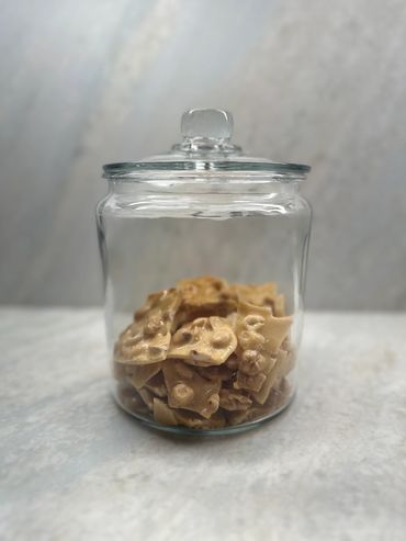Peanut brittle displayed in a jar