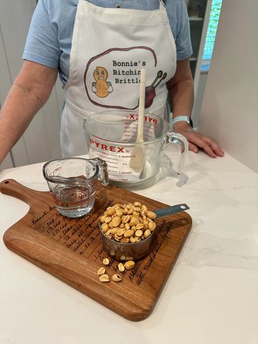 The chef with candy brittle ingredients laid out on a recipe board