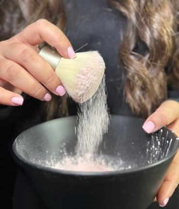 Spray tan artist showing vanilla scented drying powder
