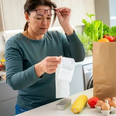 Customer viewing prices on a receipt