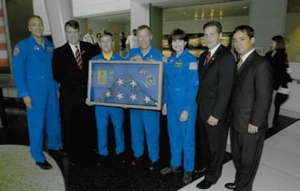 Flag rescued from Ground Zero with Space Shuttle Astronauts; Jerry Kane second from left