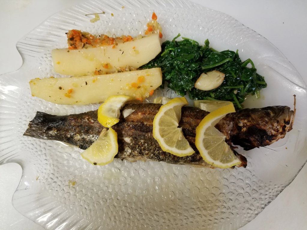 Bronzino with Riganetes Potato and Sauteed Spinach