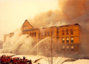 A color photo of the renovated high school on fire.
