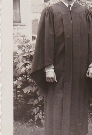 Black and white photo of Thomas E. Zebrowski and another graduate wearing caps and gowns.