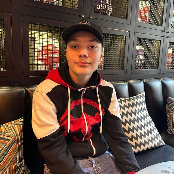 Kaiden Tidman creative assistant wearing a black hat and smiling