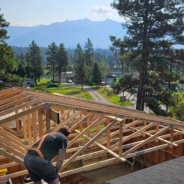 Truss installation on large-scale renovation, effectively doubling the square footage of this home.