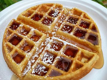 Belgian Waffle served with powdered sugar and topped with fresh strawberries