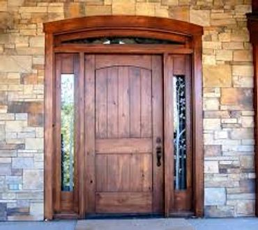 Grand wooden door entryway with windows on the sides