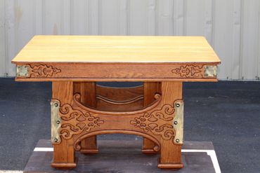 Solid wooden table with scrollwork and metal acents