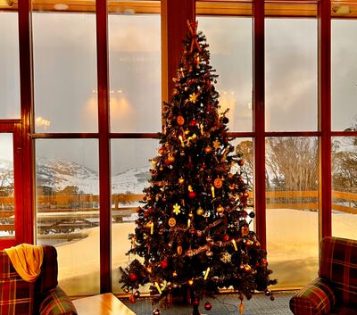 Christmas or Yule tree with Yulefest at Valhalla Perisher and snow in the background