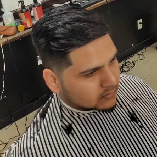 Fresh haircut with a clean fade and styled top.