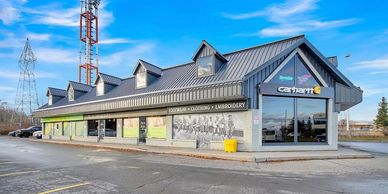 Exterior view of a commercial building with Carhartt signage on a clear day.