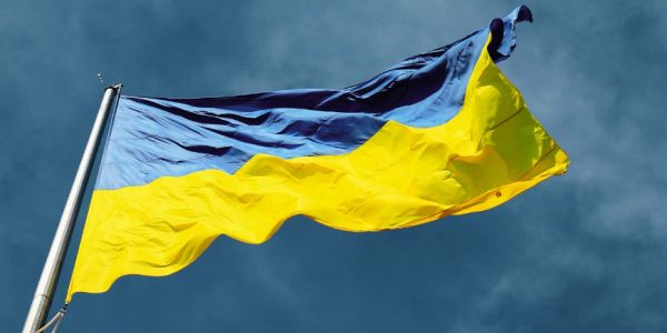 The flag of Ukraine waving against the sky.