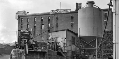 Old flour mill industrial site with machinery and storage silos.