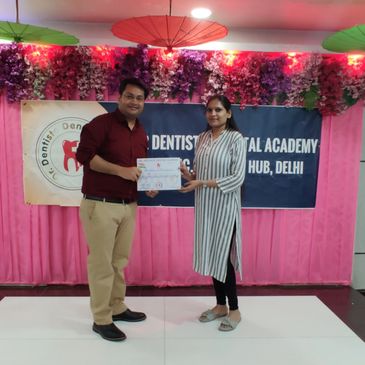 dr recieving his course completion certificate at delhi dental course 