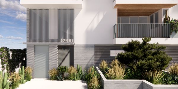Modern residential building facade with balconies and landscaped garden.
