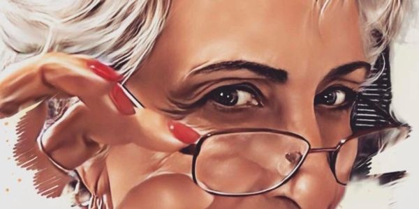 Artistic portrait of a woman with glasses and short blonde hair.
