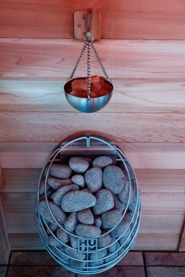 Huum sauna heater. Huum heaters focus on minimizing the metal and increasing steam from the rocks.