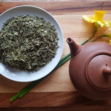 Herbal tea and Chinese tea pot with daffodils