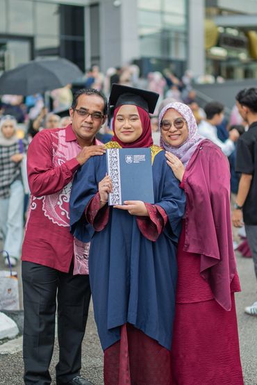 Graduate celebrating with family after ceremony