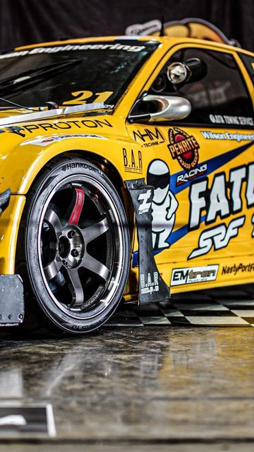 Yellow drift car at motorsport exhibition