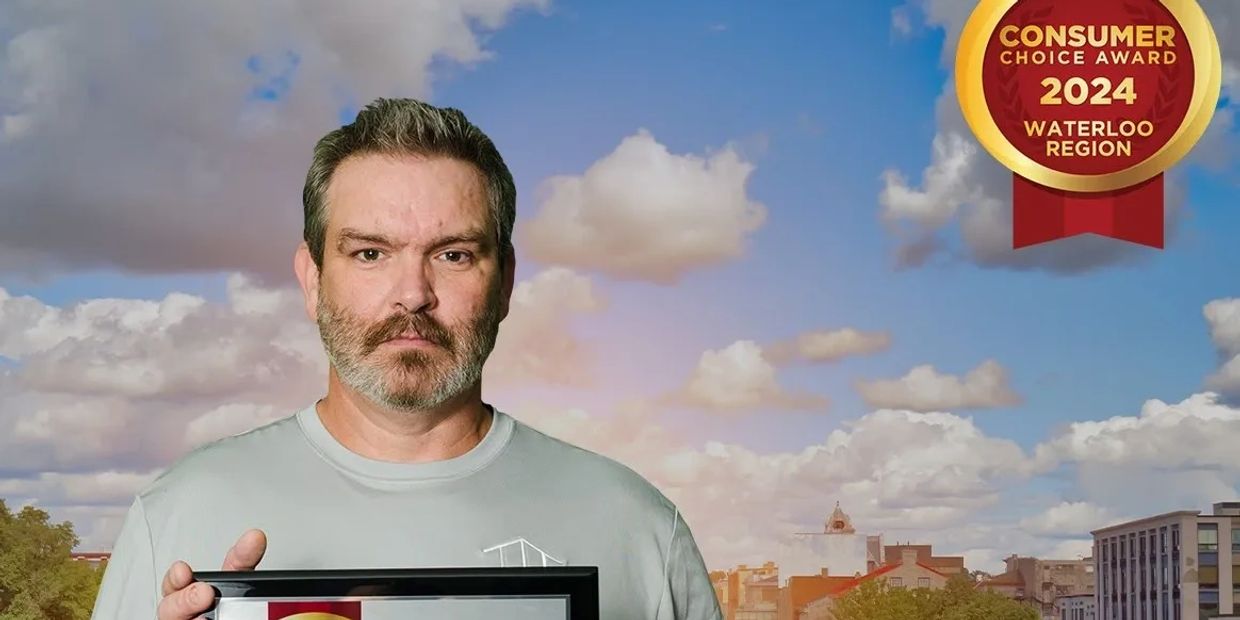 Man holding award with cloudy sky background
