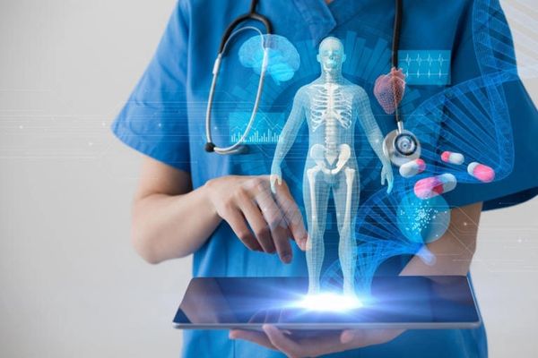 Doctor using tablet with holographic human skeleton and medical icons.