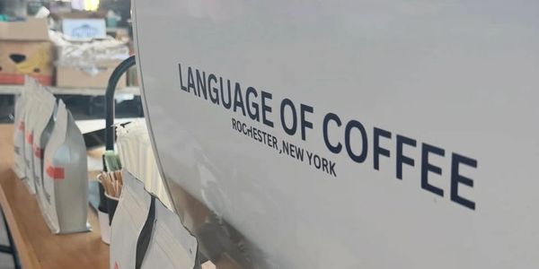 Coffee shop branding with 'Language of Coffee' text.