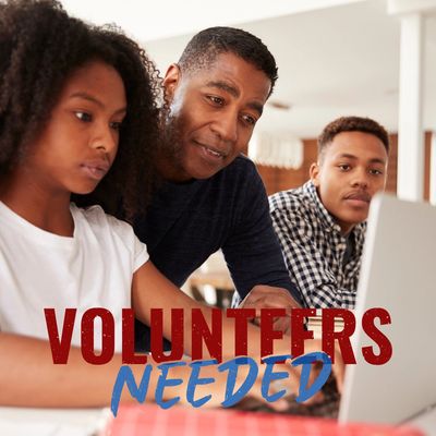 Image of a male volunteer tutoring teenagers