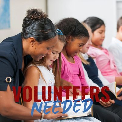 Image of a volunteer reading to a child