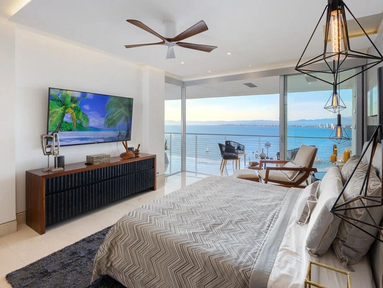 An ocean-view master bedroom with high ceilings, luxury furniture, ocean front in Puerto Vallarta. 