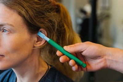 Osteopath stimulating the vagus nerve. applied neurology to down regulate and balance brainstem