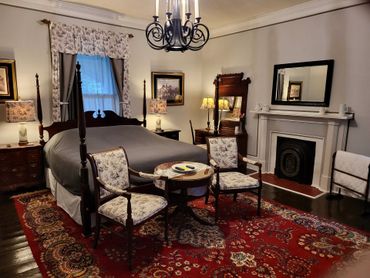 Cozy vintage bedroom with wooden furniture and floral accents.
