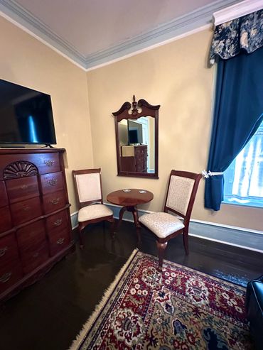 Elegant Room 1 with a four-poster bed and blue leather couch in room private Bathroom