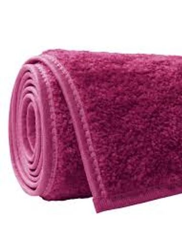 Rolled-up pink textured towel with stitched edges.