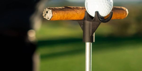 A close up shot of cigar holder with golf ball