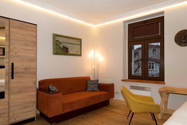 main bedroom with king size double bed and designer sofa club